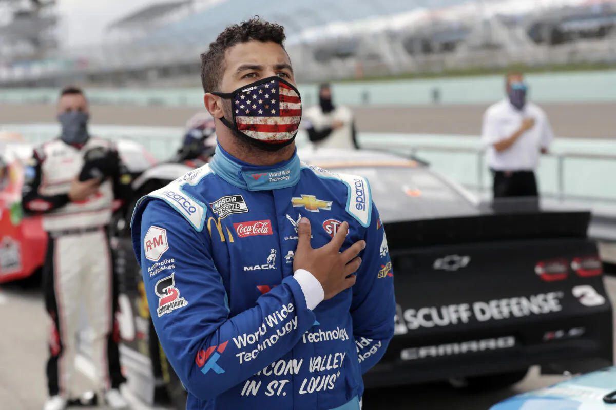 Bubba Wallace stands for the national anthem before a NASCAR Cup Series auto race in Homestead, Fla., on June 14, 2020. (Wilfredo Lee/AP Photo)