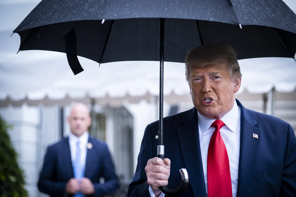 President Donald Trump stops to speak to the media in the rain on the South Lawn of the White House as he prepares to depart aboard Marine One for a rally in Tulsa, Okla., in Washington on June 20, 2020. (Pete Marovich/Getty Images)