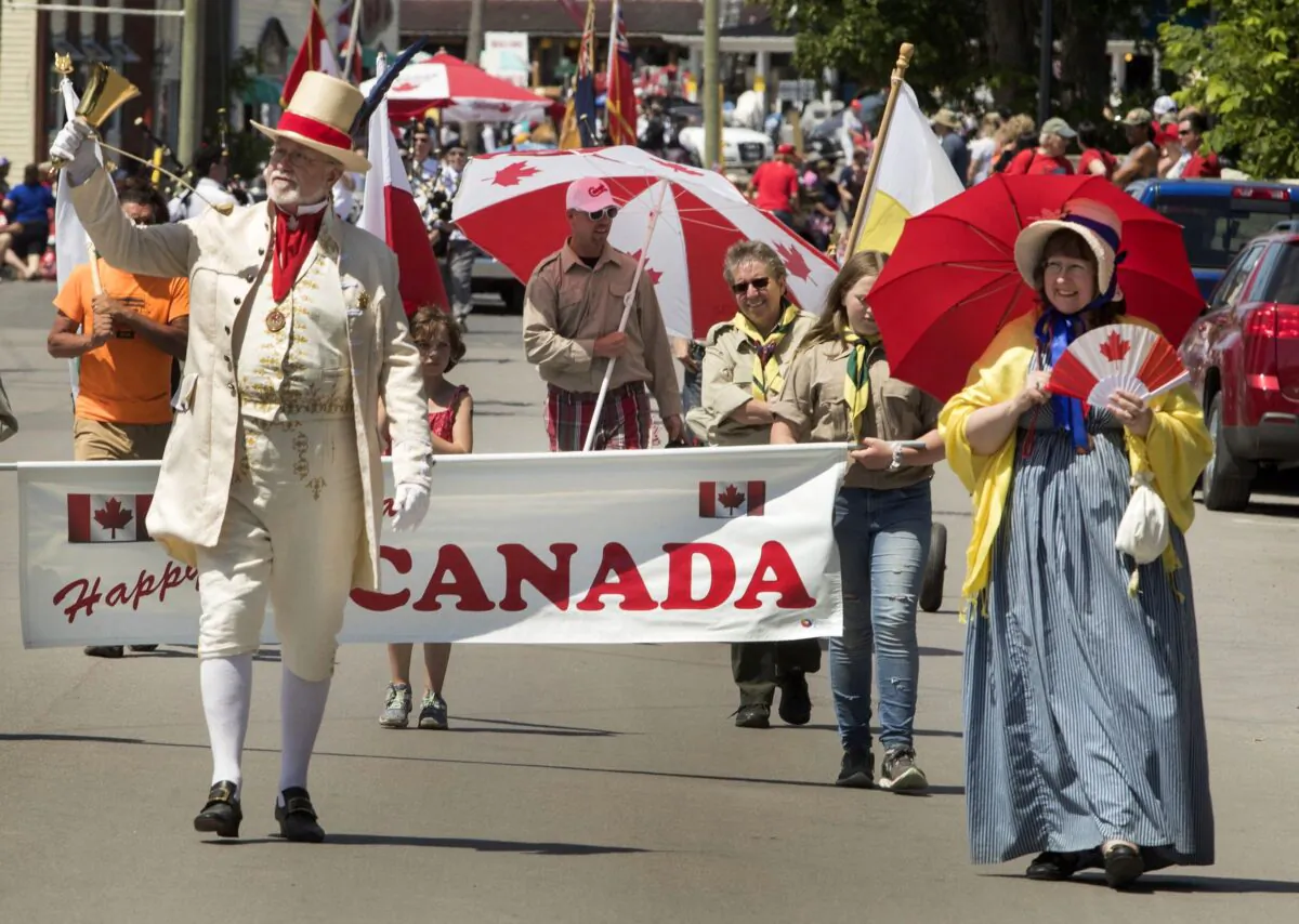 People take part in a Canada Day parade in Bobcaygeon, Ont., on July 1, 2019. (The Canadian Press/Fred Thornhill)