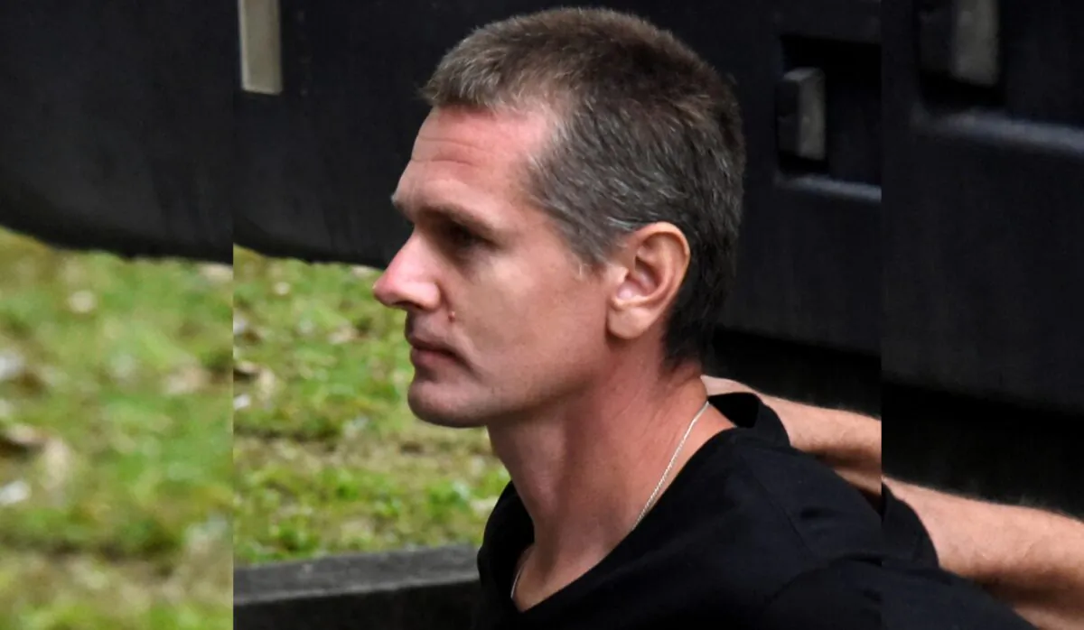 Alexander Vinnik, a 38 year old Russian man suspected of running a money laundering operation using bitcoin, is escorted by police officers to a court in Thessaloniki, Greece, on Oct. 4, 2017. (Alexandros Avramidis/Reuters, File Photo)