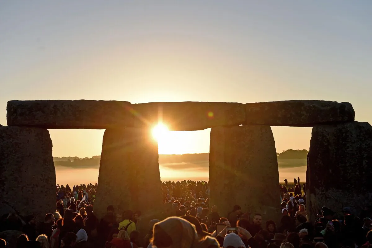 Visitors celebrate summer solstice and the dawn of the longest day of the year at Stonehenge in Amesbury, England, on June 21, 2019. (Finnbarr Webster/Getty Images)