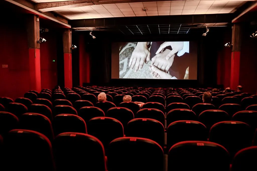 People sit in a cinema in Milan, Italy, on June 15, 2020. A new poll suggests two-thirds of Canadians don't want to relax the physical distancing rules imposed to curb the spread of COVID-19. (The Canadian Press/AP, LaPresse, Claudio Furlan)