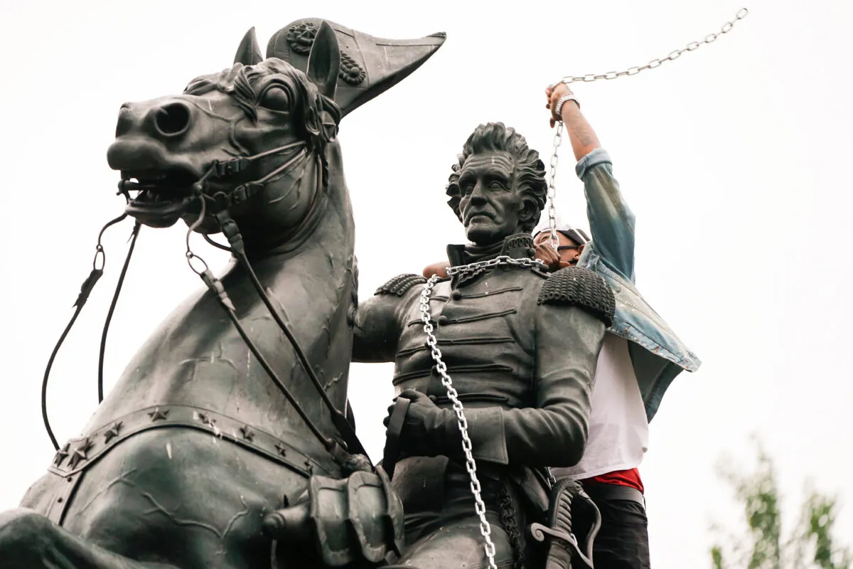 A vandal wraps chains around the neck of the statue of former President Andrew Jackson during an attempt by protesters to pull the statue down in the middle of Lafayette Park in front of the White House during racial inequality protests in Washington, on June 22, 2020. (Joshua Roberts/Reuters)