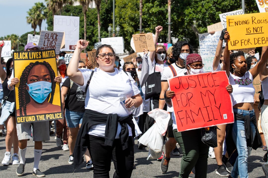 Protesters holding signs gather at Los Angeles City Hall for a protest in Los Angeles on June 19, 2020. (Valerie Macon/AFP via Getty Images)