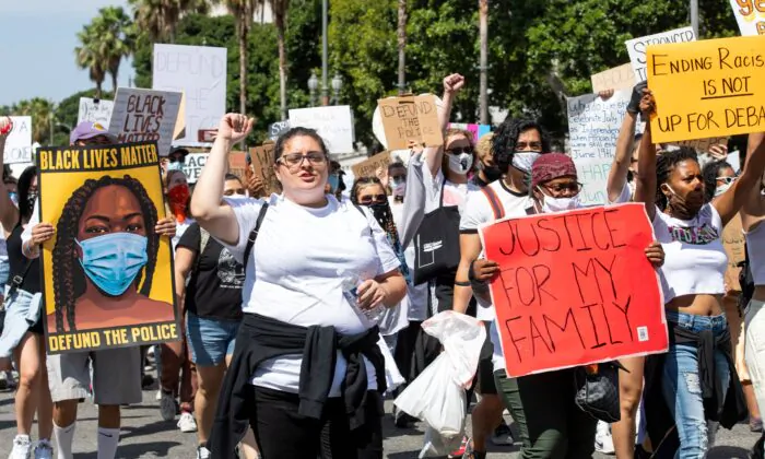 Protesters holding signs gather at Los Angeles City Hall for a protest in Los Angeles on June 19, 2020. (Valerie Macon/AFP via Getty Images)