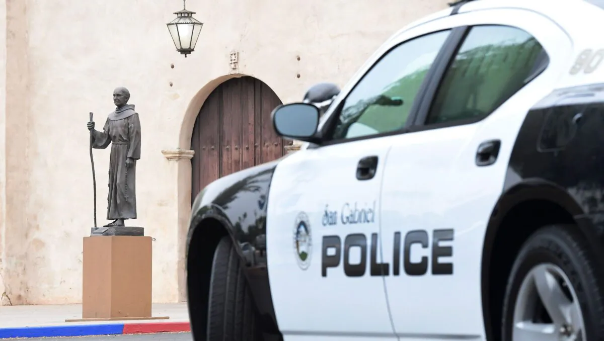 A police vehicle is parked near a statue of Father Junipero Serra in front of the San Gabriel Mission in San Gabriel, Calif., on June 21, 2020.  (FREDERIC J. BROWN/AFP via Getty Images)