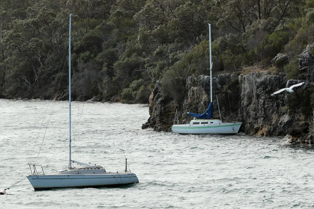 A yacht having broken it's mooring is seen against the rock wall at Blackwall Reach in Bicton on May 25, 2020 in Perth, Australia. (Paul Kane/Getty Images)