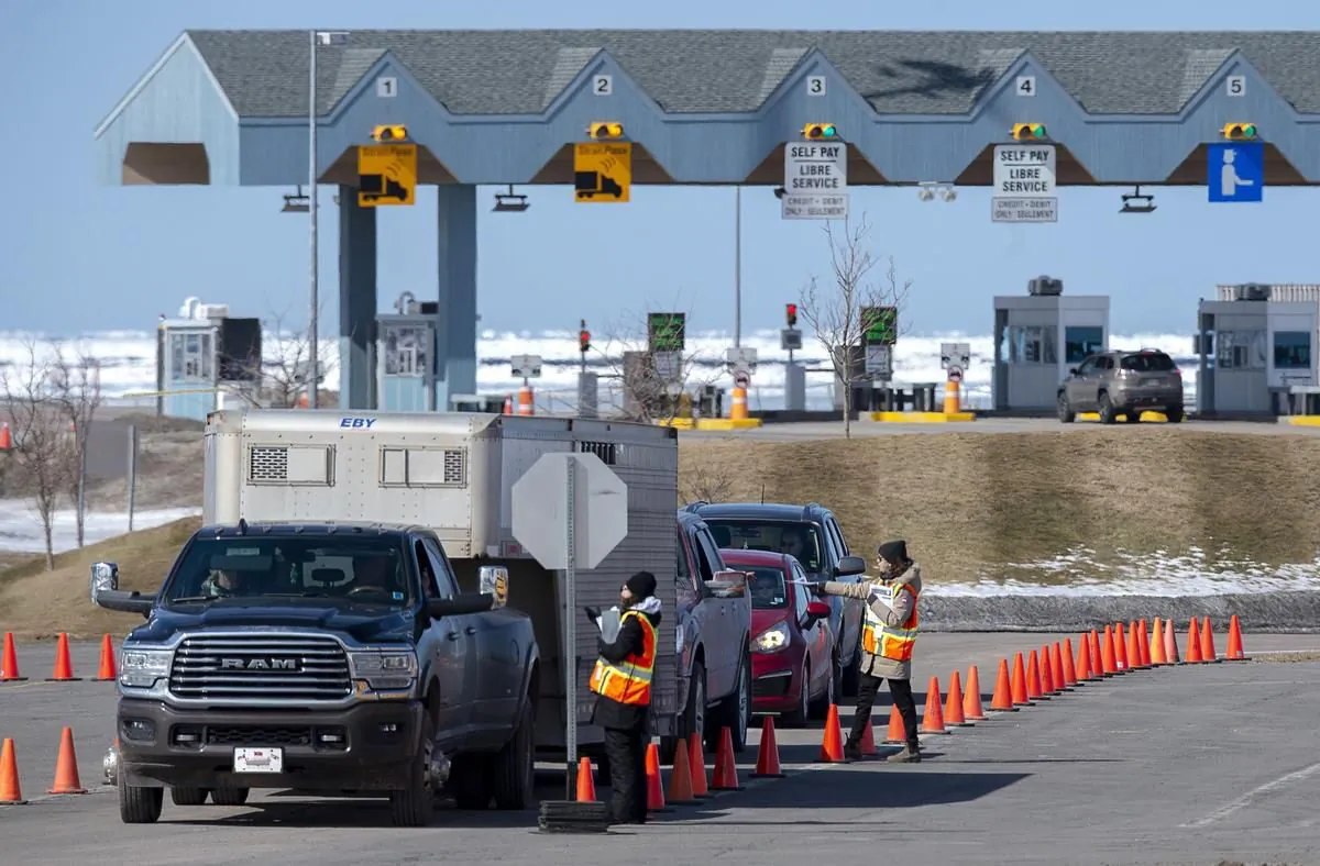 The four Atlantic provinces have announced plans to ease interprovincial travel restrictions, creating a so-called Atlantic bubble as the region has reported relatively few COVID-19 infections in recent weeks. Provincial health department workers stop traffic that has crossed the Confederation Bridge in Borden-Carleton, P.E.I., on March 22, 2020. (Andrew Vaughan/THE CANADIAN PRESS)