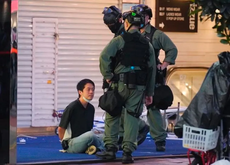 Hui Chi-fung, left, a Democratic Party politician, is detained by riot police during a protest in Causeway Bay, Hong Kong, on June 12, 2020. (The Canadian Press/AP/Vincent Yu)