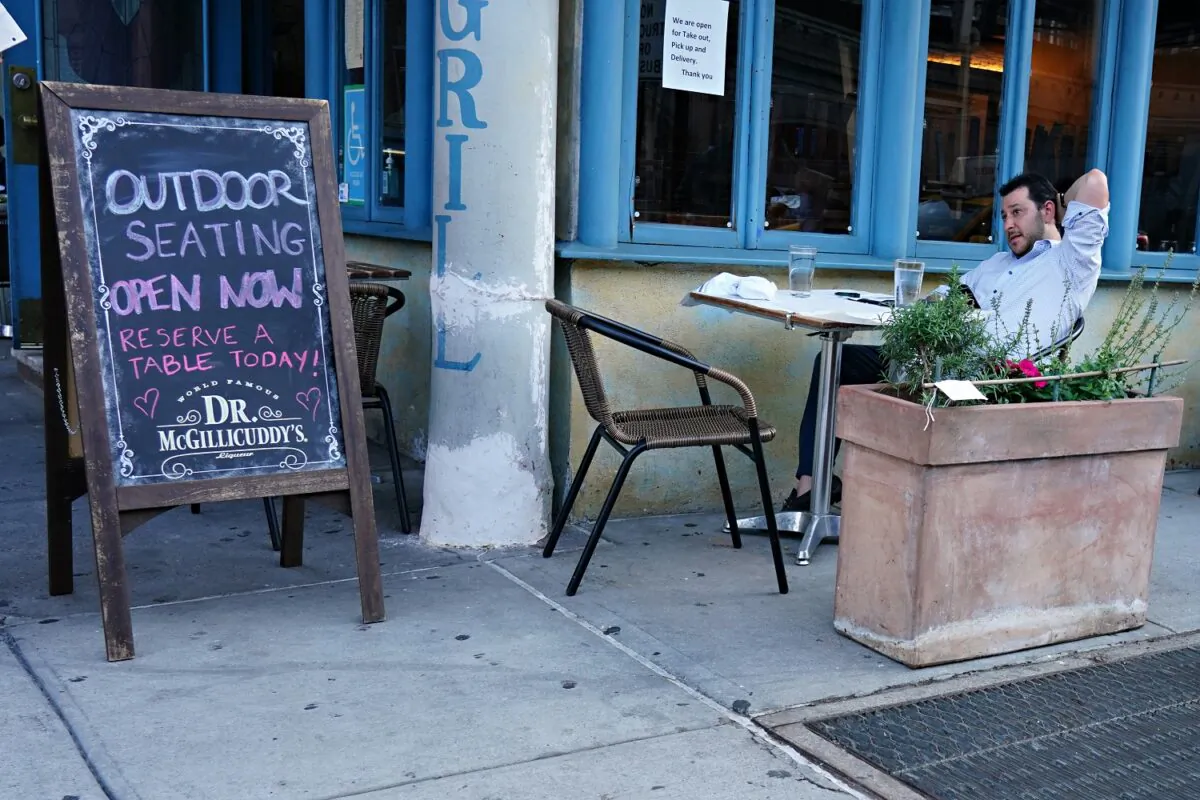 A restaurant serves customers seated at outside tables as the city moves into Phase 2 of re-opening following restrictions imposed to curb the coronavirus pandemic in New York City on June 22, 2020. Phase 2 permits the reopening of offices, in-store retail, outdoor dining, barbers, and beauty parlors and numerous other businesses. (Cindy Ord/Getty Images)