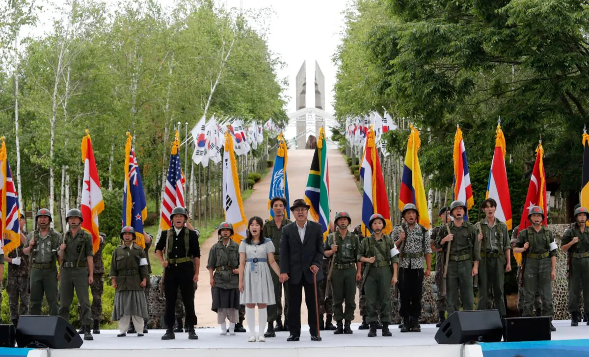 Actors wearing military uniforms with flags of countries which participated in the Korean War perform during a ceremony to mark the 70th anniversary of the outbreak of the Korean War in Cheorwon, near the border with North Korea, South Korea, on June 25, 2020. (Ahn Young-joon/AP Photo)