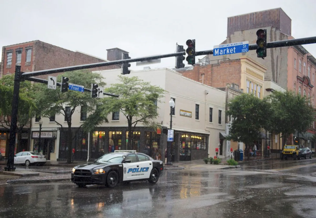 A police car drives through an intersection in Wilmington, North Carolina, on Sept. 13, 2018. (Andrew Caballero/AFP/Getty Images)