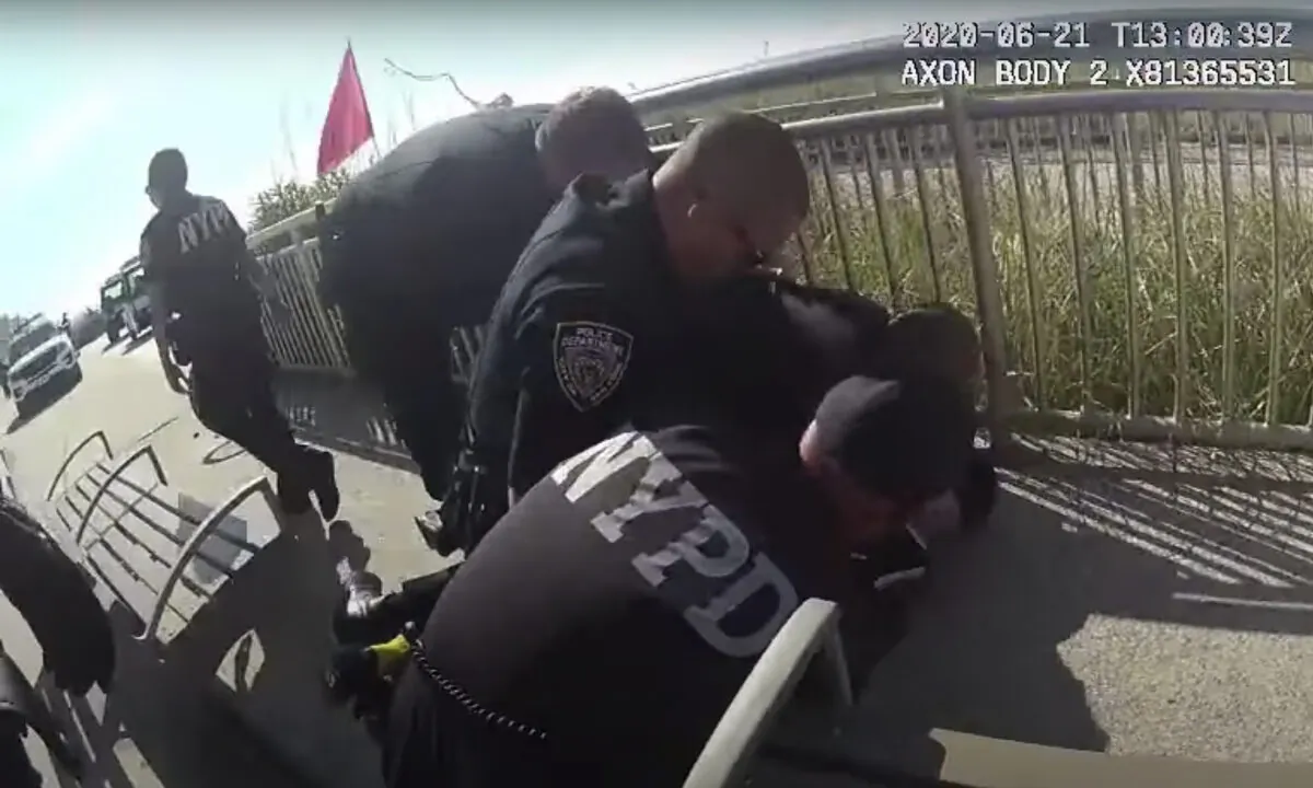 In this photo taken from police body cam video, New York Police officers arrest a man on a boardwalk in Queens on June 21, 2020. (NYPD/AP)
