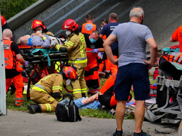 First responders treat the injured at the scene of a public bus crash,