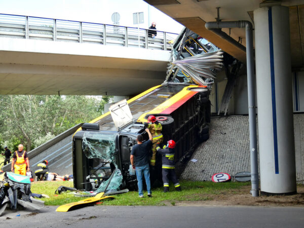 Fire crews climb onto a public bus at the scene its crash