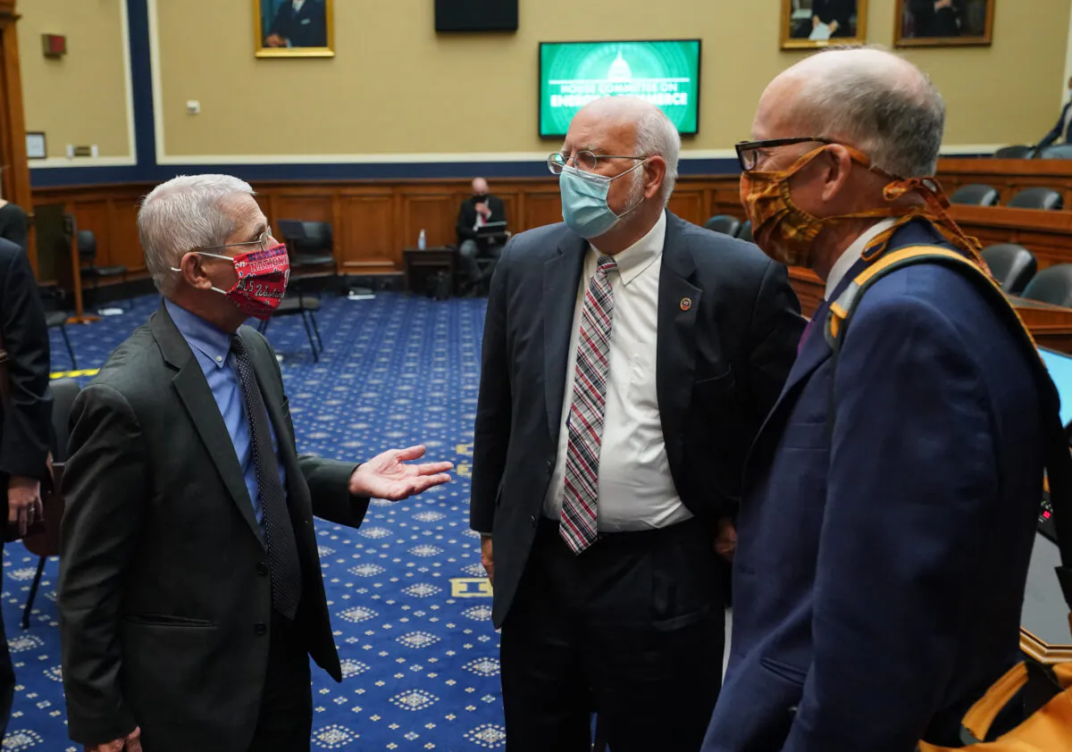 (L-R) Dr. Anthony Fauci, director of the National Institute for Allergy and Infectious Diseases, Dr. Robert Redfield, director of the Centers for Disease Control and Prevention, and Ranking Member Greg Walden (R-OR) talk after after testifying during a House Energy and Commerce Committee hearing on the Trump Administration's Response to the COVID-19 Pandemic, on Capitol Hill in Washington, DC, on June 23, 2020. (Photo by Kevin Dietsch/various sources/AFP via Getty Images)