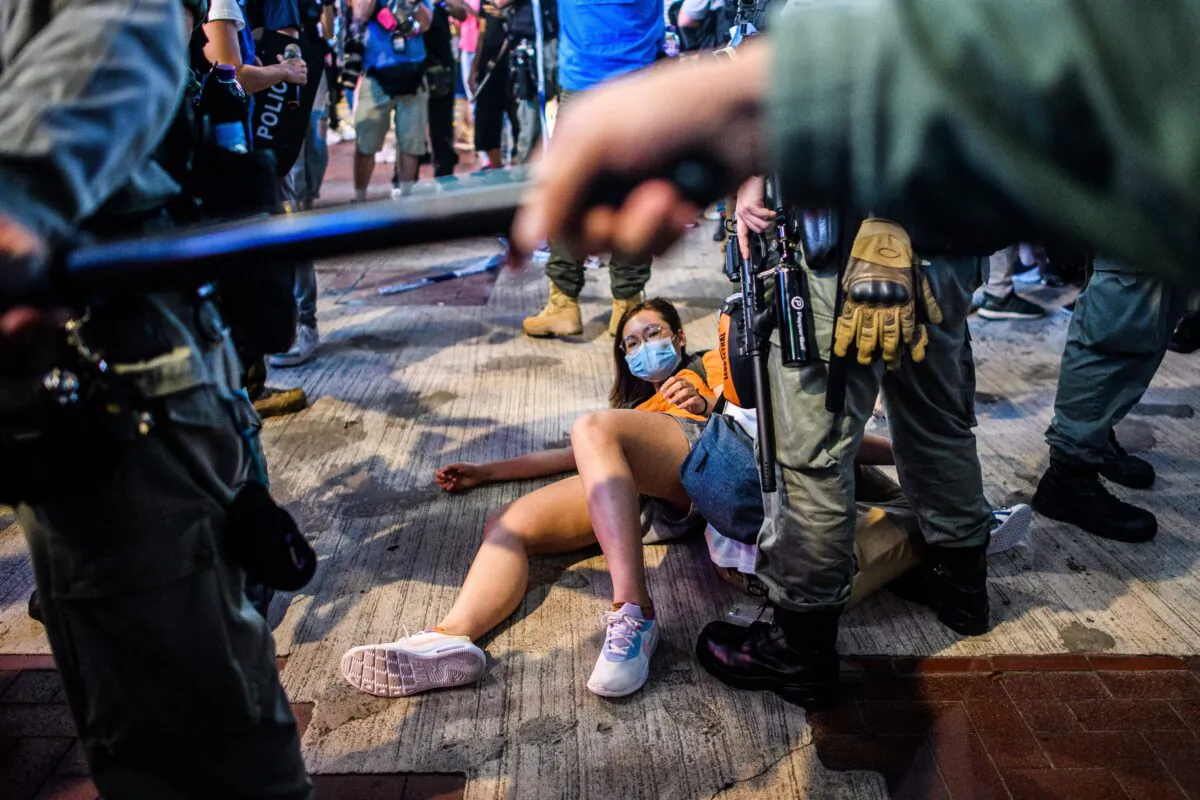 People are detained as pro-democracy protesters gather in the Causeway Bay district of Hong Kong on June 12, 2020. (Anthony Wallace/AFP via Getty Images)