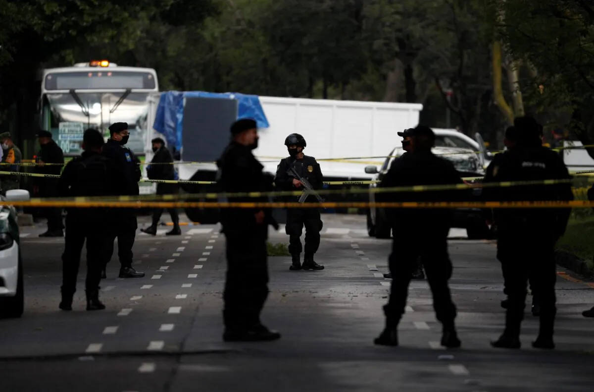 Police stand guard at a crime scene in a file photo. (Rebecca Blackwell/AP Photo)