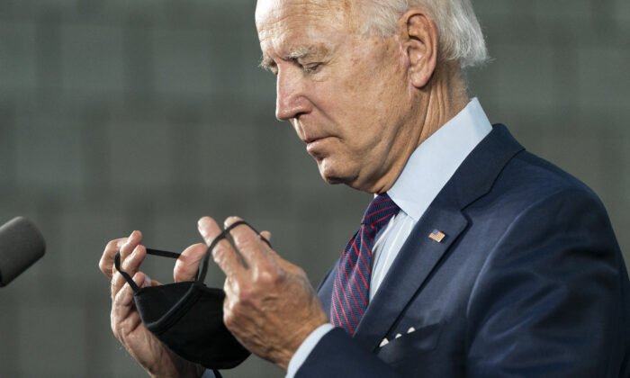 Democratic presidential candidate former Vice President Joe Biden puts on a mask after speaking during an event about affordable healthcare at the Lancaster Recreation Center in Lancaster, Pa., on June 25, 2020. (Joshua Roberts/Getty Images)