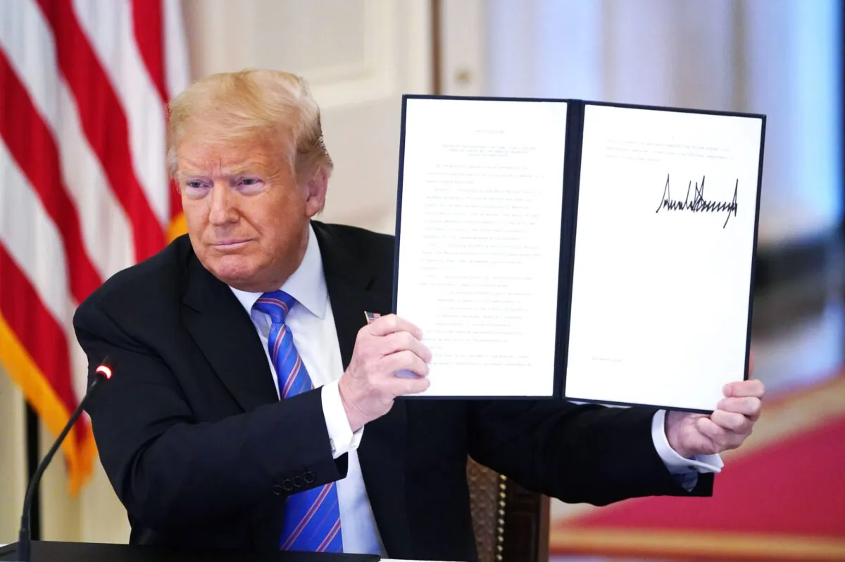 President Donald Trump holds an executive order on "Continuing the President's National Council for the American Worker and the American Workforce Policy Advisory Board" in the East Room of the White House in Washington, on June 26, 2020. (Mandel Ngan/AFP via Getty Images)