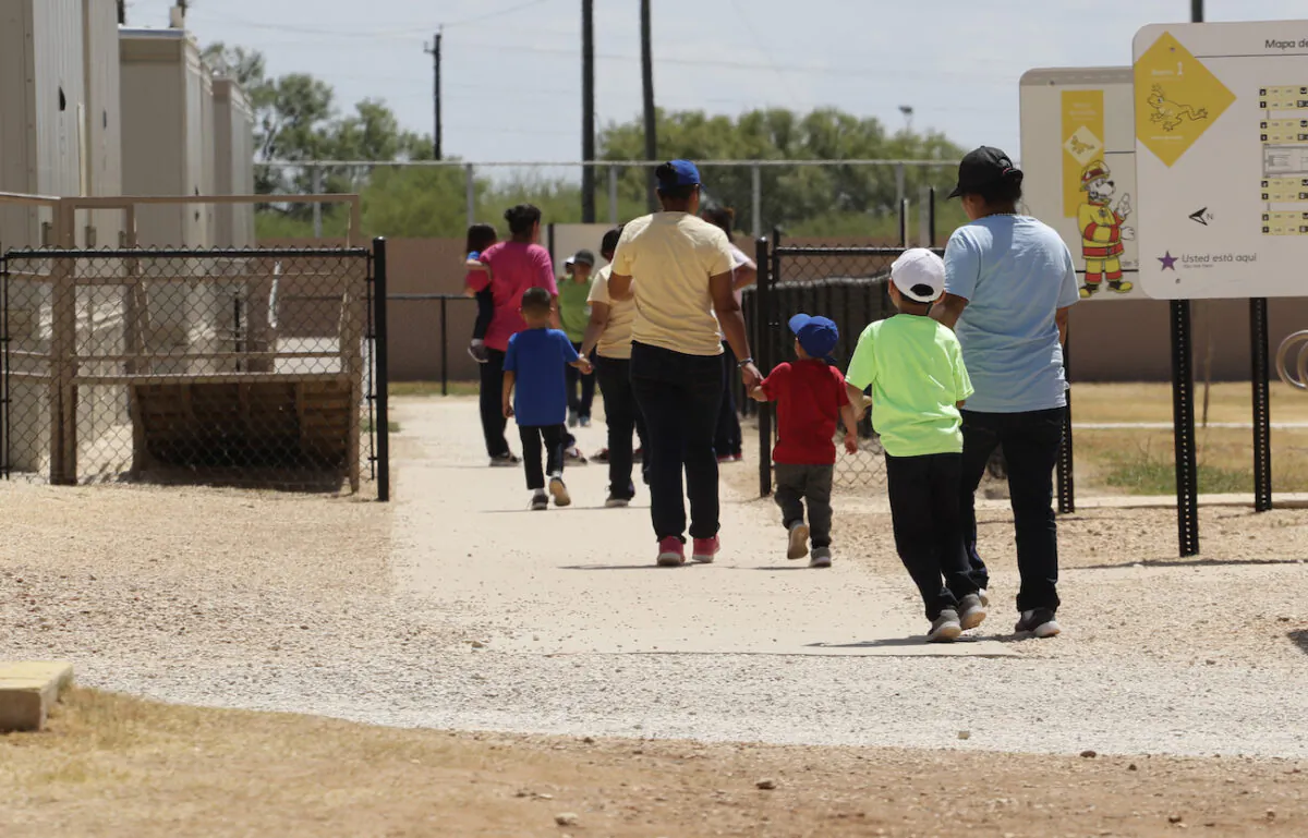 People hold hands as they leave a cafeteria at the ICE South Texas Family Residential Center in Dilley, Texas, on Aug. 23, 2019.  (AP Photo/Eric Gay, File)