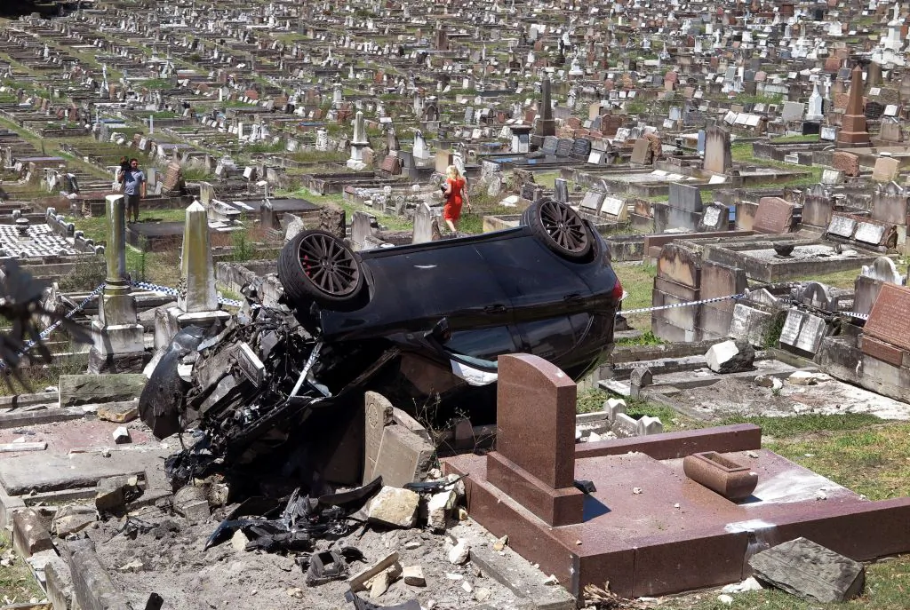 A Mercedes SUV lies amongst the gravestones at a cemetery in the Sydney suburb of South Coogee on February 6, 2018.
(WILLIAM WEST/Getty Images)