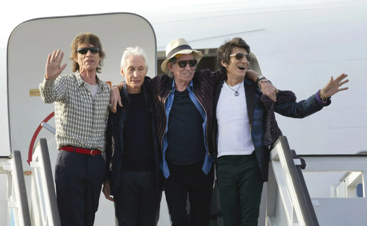 Members of The Rolling Stones, from left, Mick Jagger, Charlie Watts, Keith Richards and Ron Wood pose for photos from the plane that brought them to Cuba at Jose Marti international airport in Havana, Cuba, on March 24, 2016. (Ramon Espinosa/AP Photo)
