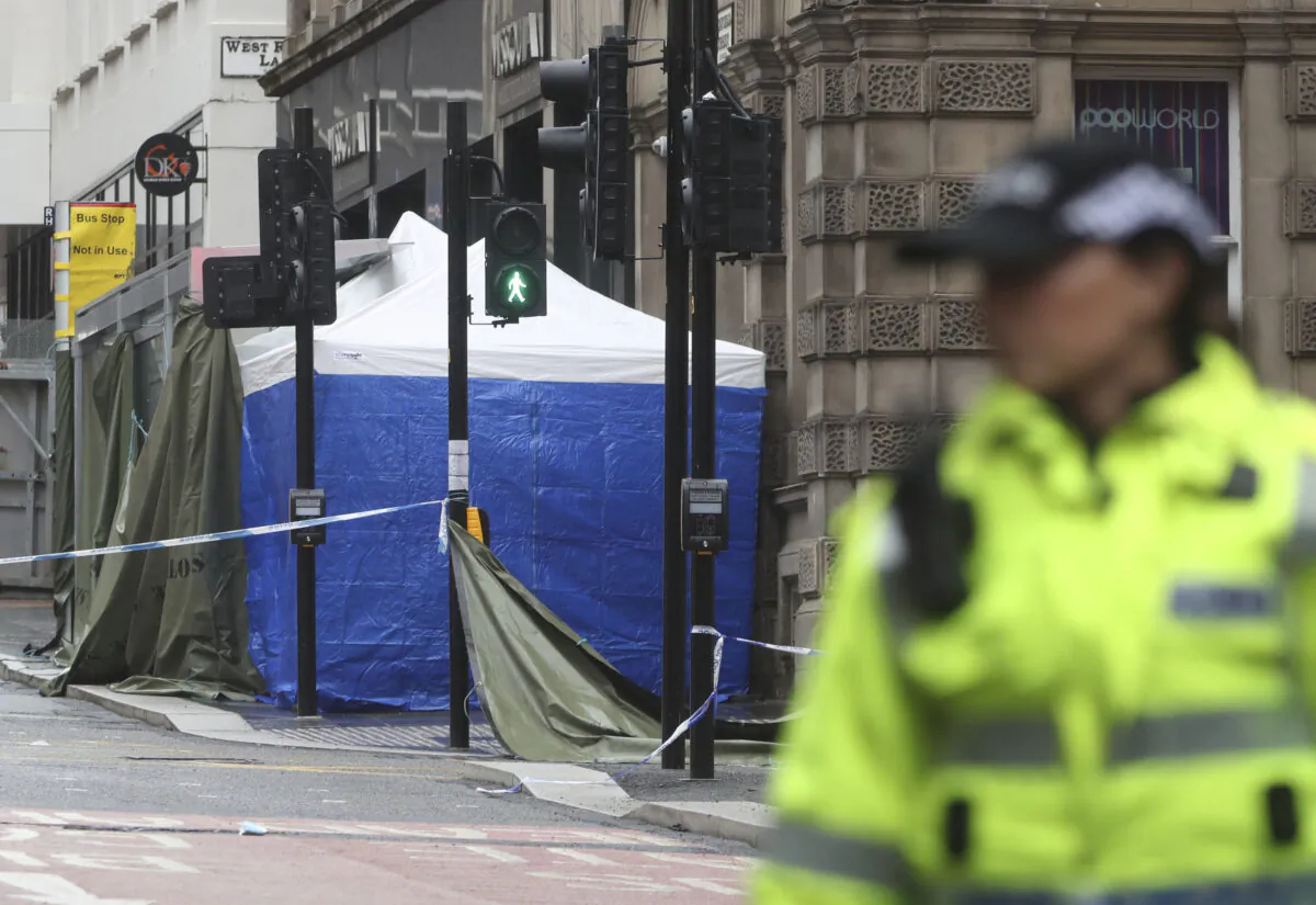 A police Incident tent at the scene where a man was shot by armed officers after another police officer was injured during an attack on Friday, in Glasgow, Scotland, as investigations continue Sunday June 28, 2020. (Andrew Milligan/PA via AP)