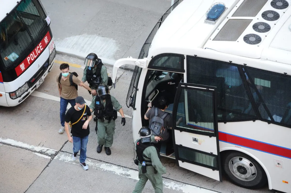 Protesters are arrested by local police in Mong Kok, Hong Kong, on June 28, 2020. (Song Bilung/The Epoch Times)