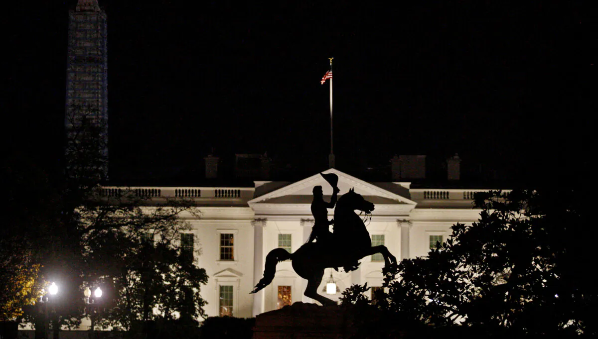 The statue of U.S. President Andrew Jackson on his horse in the center of Lafayette Park is silhouetted against the White House in front of the Washington Monument in Washington on Nov. 17, 2013. (Jim Bourg/Reuters)