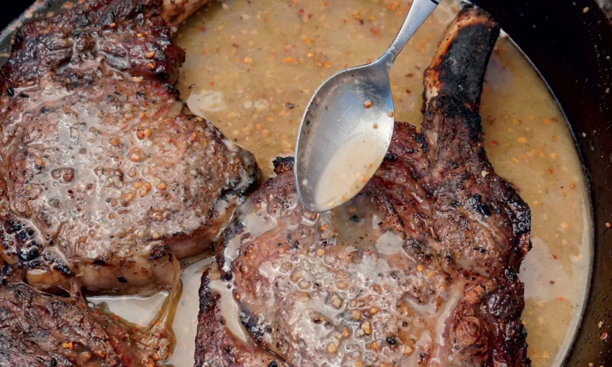 The steaks are finished in a cast-iron skillet with butter, garlic, horseradish, and white wine. (Photo by Shannon Rollins)