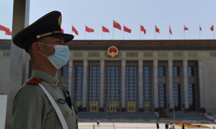 A paramilitary policeman stands guard outside the Great Hall of the People ahead of the closing session of the National People's Congress in Beijing on May 28, 2020. (Nicolas Asfouri/AFP via Getty Images)