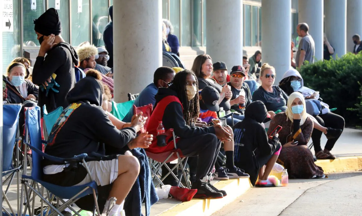 Hundreds of unemployed Kentucky residents wait in long lines outside the Kentucky Career Center for help with their unemployment claims, in Frankfort, Kentucky, on June 19, 2020. (John Sommers II/Getty Images)