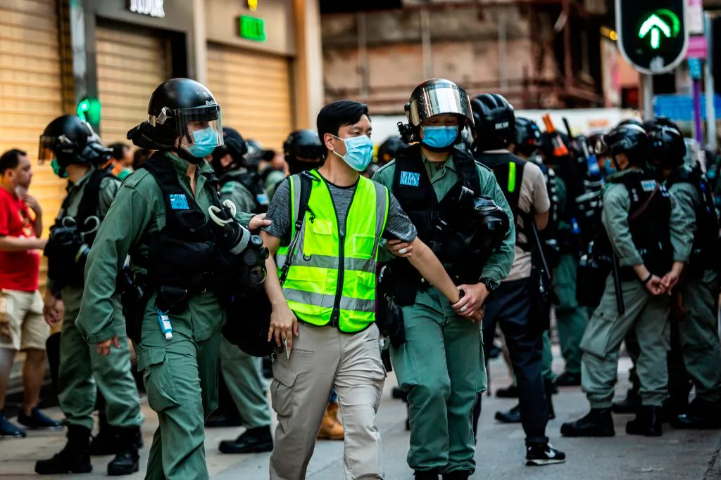 Police arrest a man (C) and lead him to a nearby bus during a protest against China's planned national security law in Hong Kong on June 28, 2020. (Issac Lawrence/AFP via Getty Images)