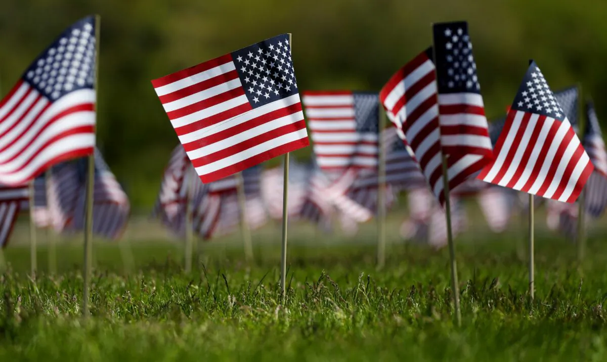 Flags wave in the wind outside of Gillette Stadium in Foxborough, Mass., on May 21, 2020. The Patriots foundation partnered with the Massachusetts Military Heroes fund to plant 2,552 flags to honor veterans from Foxborough who have lost their lives defending the country since the Revolutionary War. (Maddie Meyer/Getty Images)