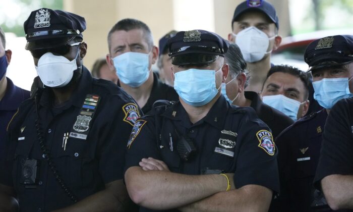 NYPD Police officers listen as Police Benevolent Association of the City of New York President Pat Lynch and representatives from other NYPD and law enforcement unions holds a news conference at the Icahn Stadium parking lot in New York on June 9, 2020. (Timothy A. Clary/AFP via Getty Images)