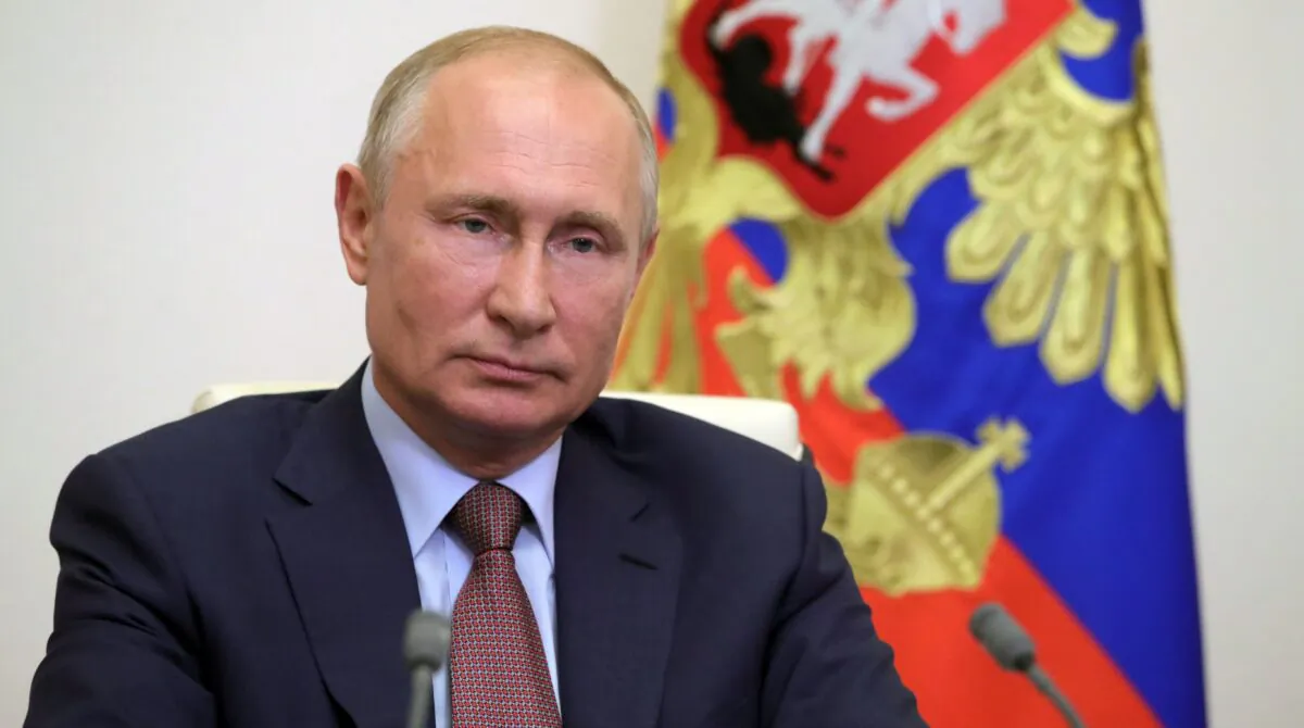 Russian President Vladimir Putin speaks with French President Emmanuel Macron during a video conference at the Novo-Ogaryovo state residence outside Moscow, Russia, on June 26, 2020. (Mikhail Klimentyev/ SPUTNIK / AFP via Getty Images)