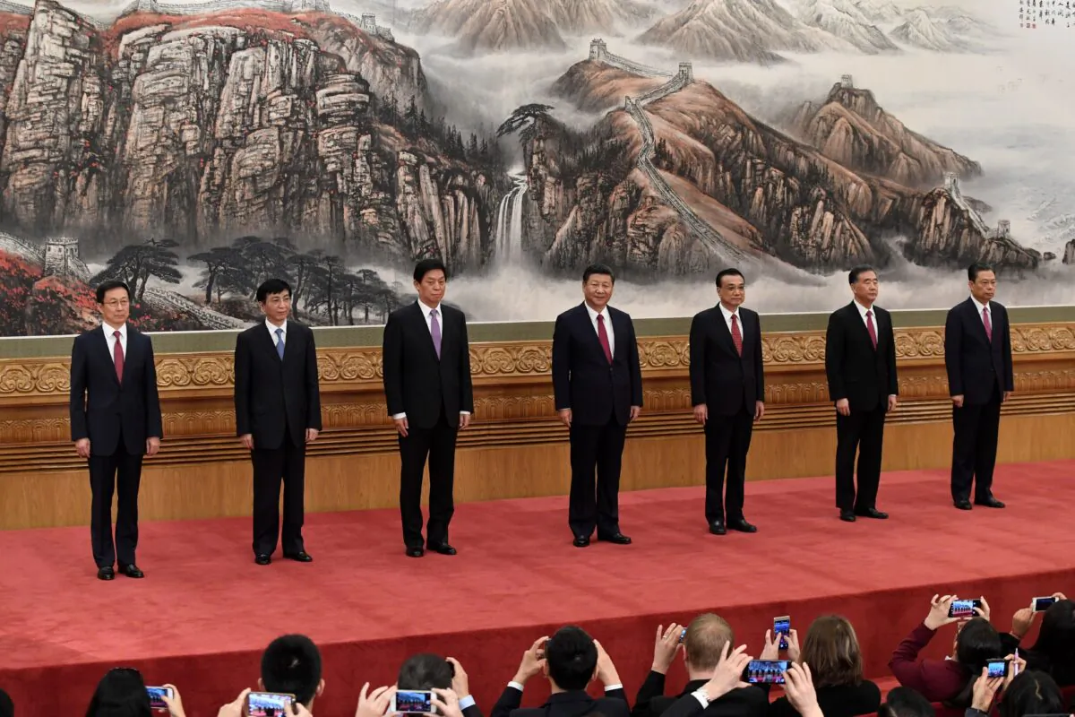 The Chinese Communist Party's Politburo Standing Committee, the nation's top decision-making body (L-R): Han Zheng, Wang Huning, Li Zhanshu, Chinese leader Xi Jinping, Premier Li Keqiang, Wang Yang, and Zhao Leji meet the press at the Great Hall of the People in Beijing on Oct. 25, 2017. (Wang Zhao/AFP via Getty Images)