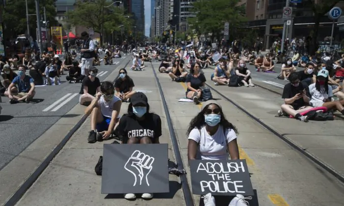 Thousands of people protest to defund the police in support of Black Lives Matter in Toronto, Canada, on June 19, 2020. (Nathan Denette/The Canadian Press)