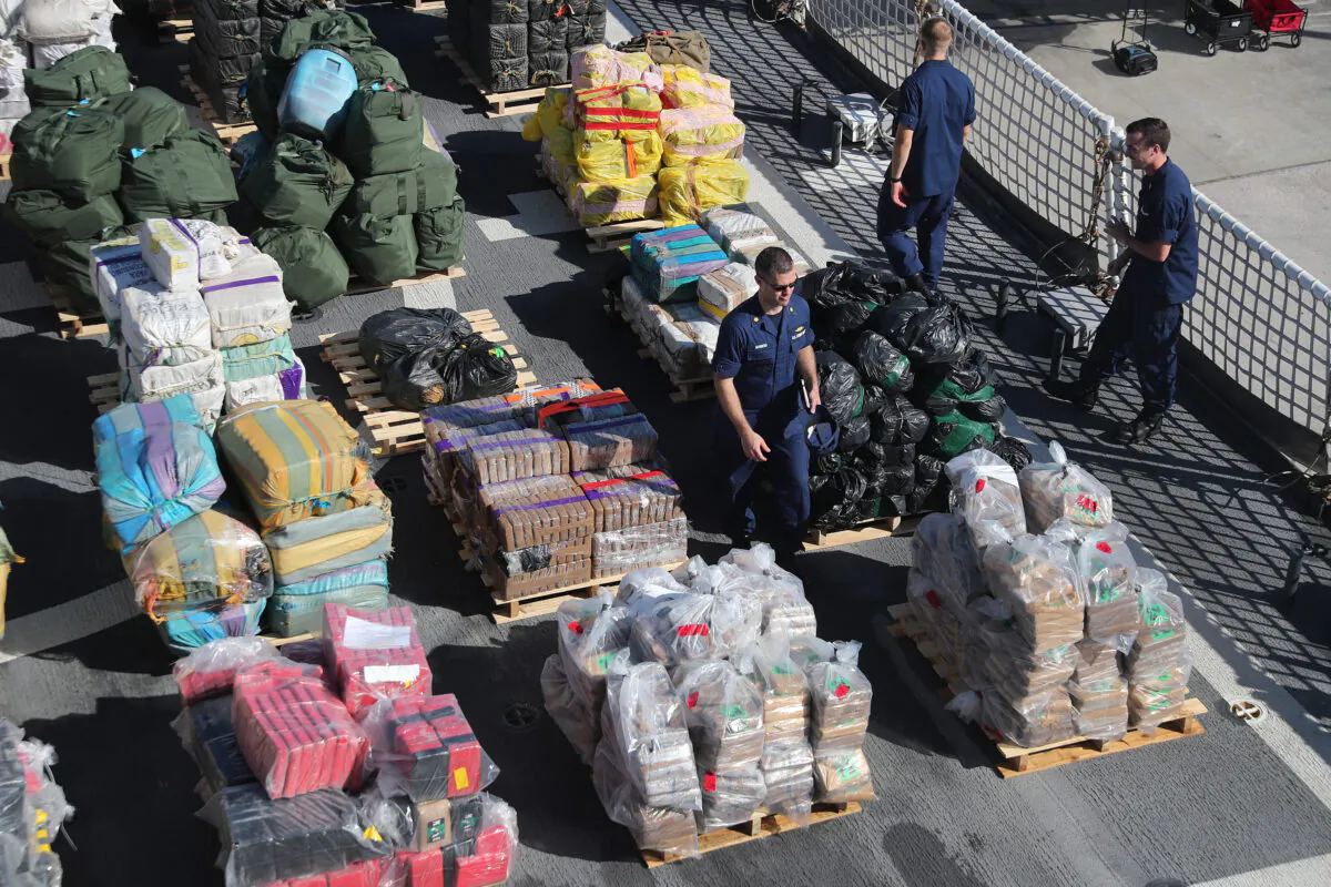 The crew of the Coast Guard Cutter James is seen on deck as wrapped packages of approximately 27,300 pounds of cocaine and 11,000 pounds marijuana is prepared to be offloaded at Port Everglades in Fort Lauderdale, Fla., on Oct. 28, 2019. (Joe Raedle/Getty Images)