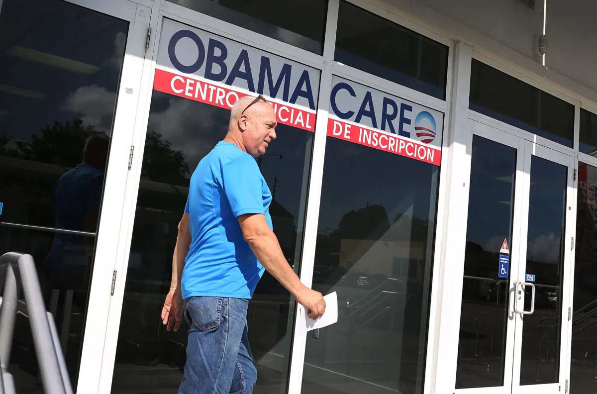 Alberto Abin walks out of the UniVista Insurance company office after shopping for a health plan under the Affordable Care Act, also known as Obamacare, in Miami, Fla., on Dec. 2015. (Joe Raedle/Getty Images)
