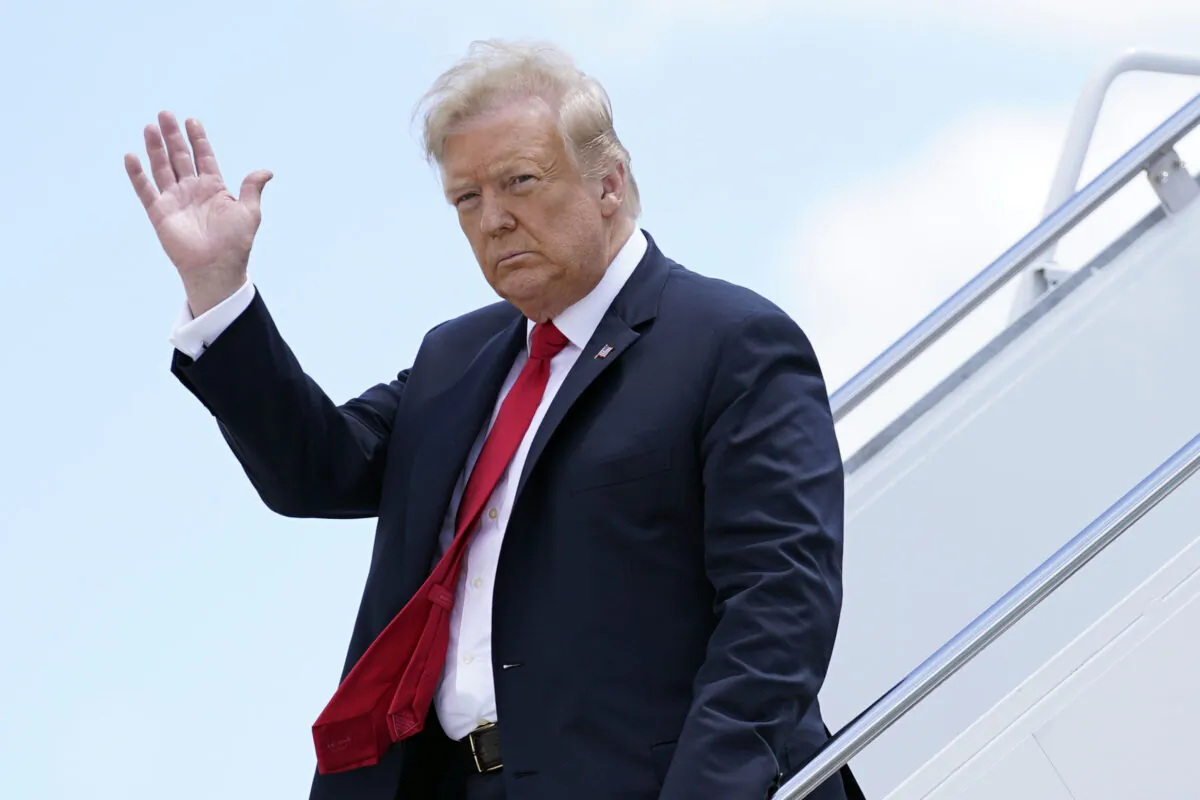 President Donald Trump waves as he arrives on Air Force One at Austin Straubel International Airport in Green Bay, Wis., on June 25, 2020.  (Evan Vucci/File/AP Photo)