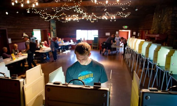 Voters fill out their ballots for the presidential primary in a log cabin run by the American Legion in San Anselmo, Calif., on March 3, 2020. (Josh Edelson/AFP via Getty Images)