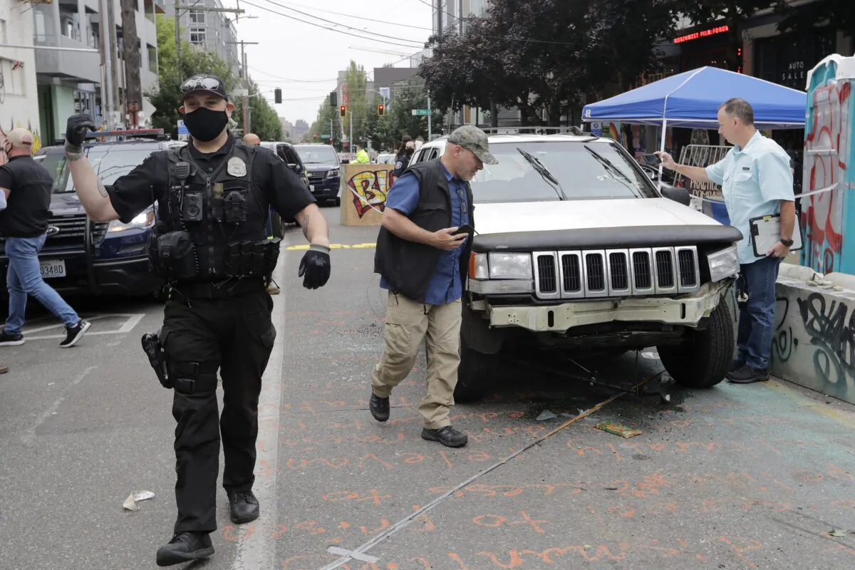 A car sits in the Capitol Hill Organized Protest zone following a shooting in Seattle, Wash., on June 29, 2020. (Aron Ranen/AP Photo)