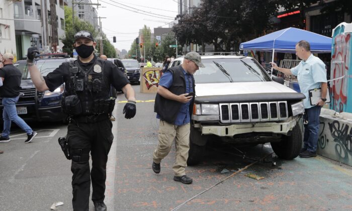 A car sits in the Capitol Hill Organized Protest zone following a shooting in Seattle, Wash., on June 29, 2020. (Aron Ranen/AP Photo)