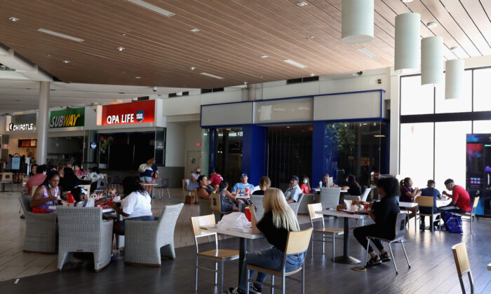 Consumers sit in the food court as they return to retail shopping at the Arrowhead Towne Center in Glendale, Ariz., on June 20, 2020. (Christian Petersen/Getty Images)