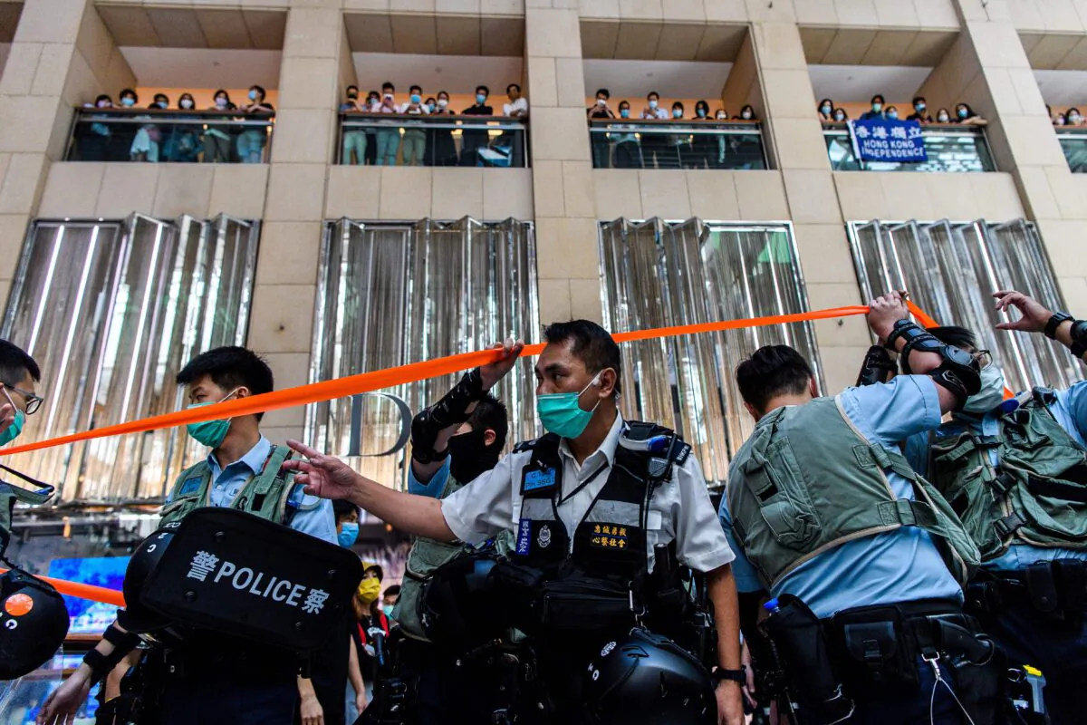 Police enter a shopping mall to disperse people attending a lunchtime rally in Hong Kong on June 30, 2020, as China passed a sweeping national security law for the city. (Anthony Wallace/AFP via Getty Images)