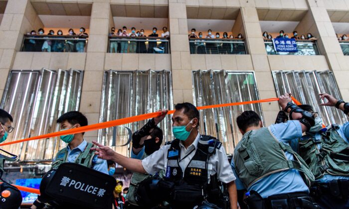 Police enter a shopping mall to disperse people attending a lunchtime rally in Hong Kong on June 30, 2020, as China passed a sweeping national security law for the city. (Anthony Wallace/AFP via Getty Images)