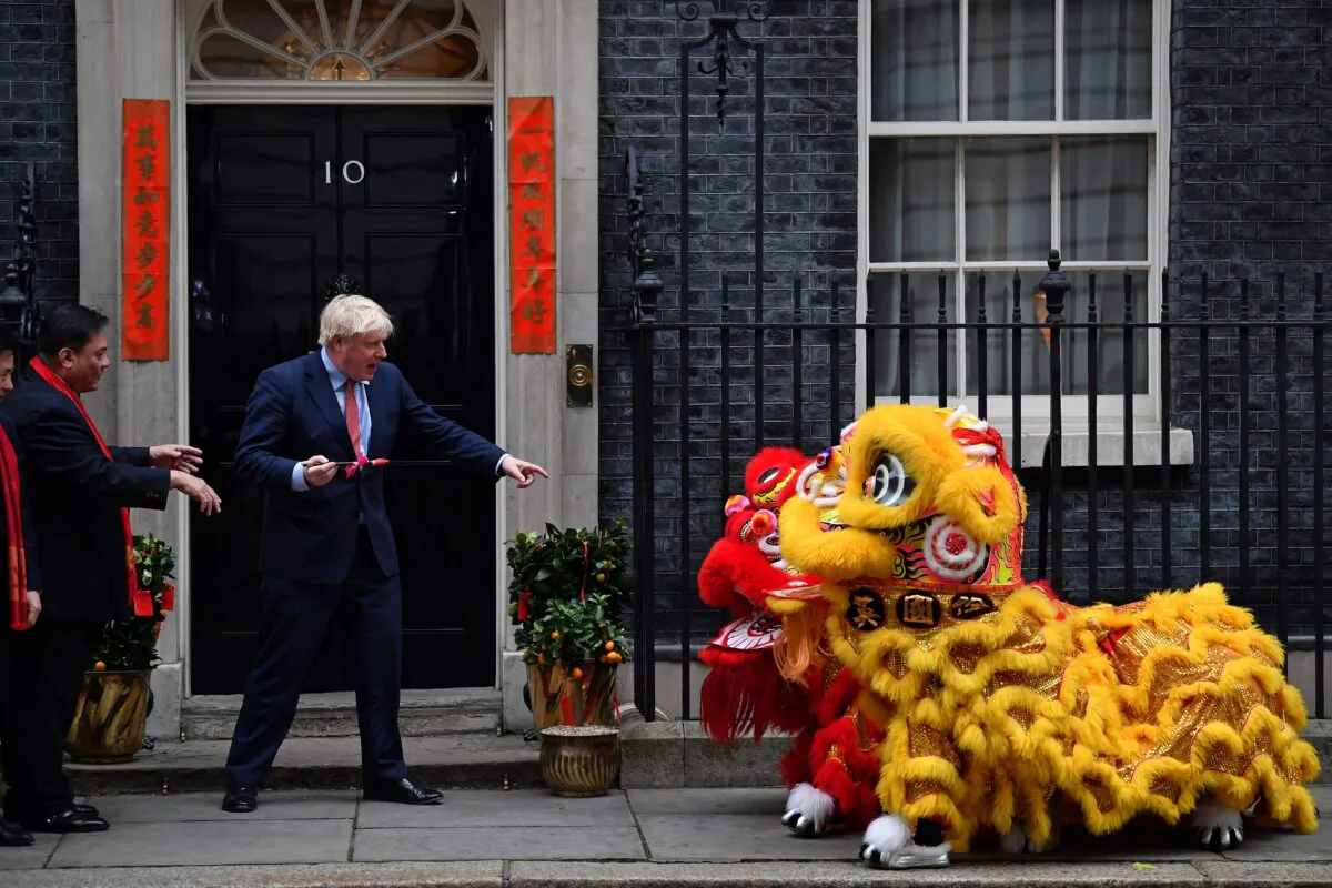 Britain's Prime Minister Boris Johnson prepares to paint the eyes on Chinese Lions, as he hosts a Chinese New Year reception at 10 Downing Street in central London on Jan. 24, 2020. (Ben Stansall/AFP via Getty Images)