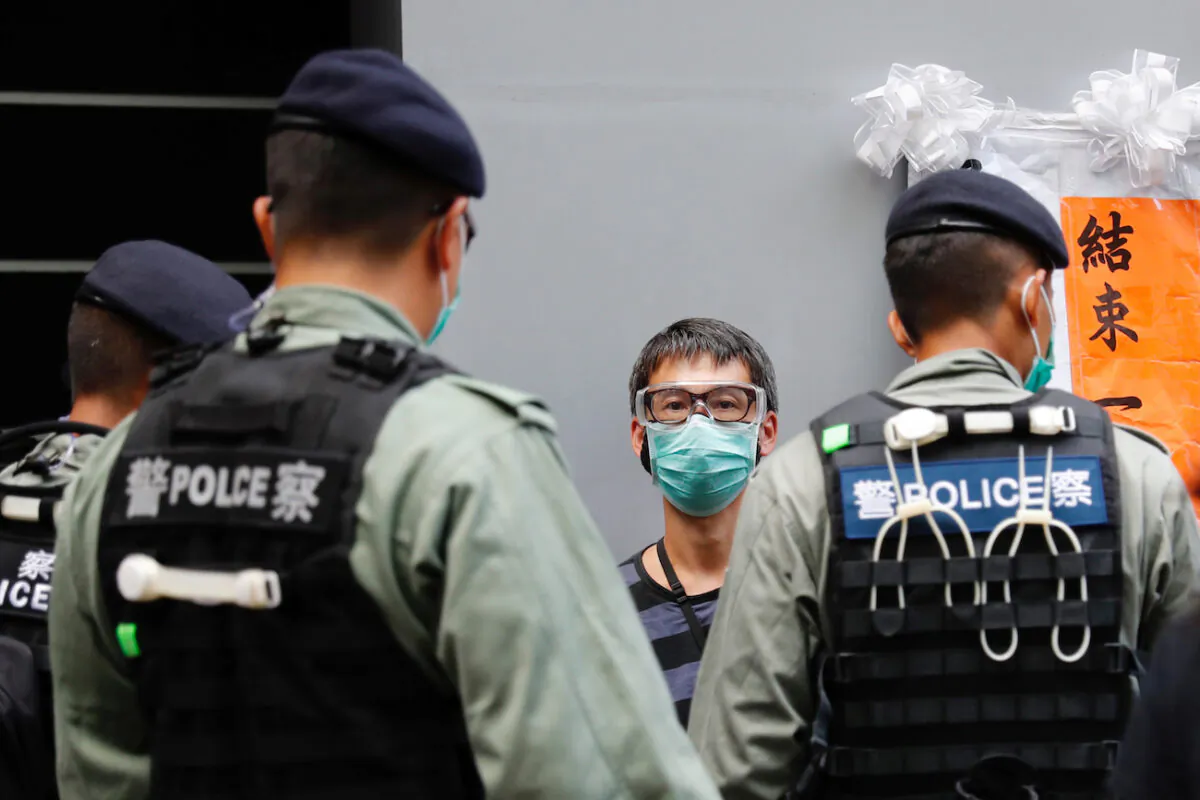 Police search a pro-democracy protester during a demonstration on July 1, 2020. (Tyrone Siu/Reuters)